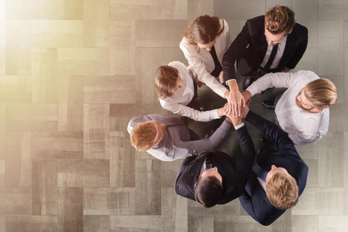 Business people putting their hands together