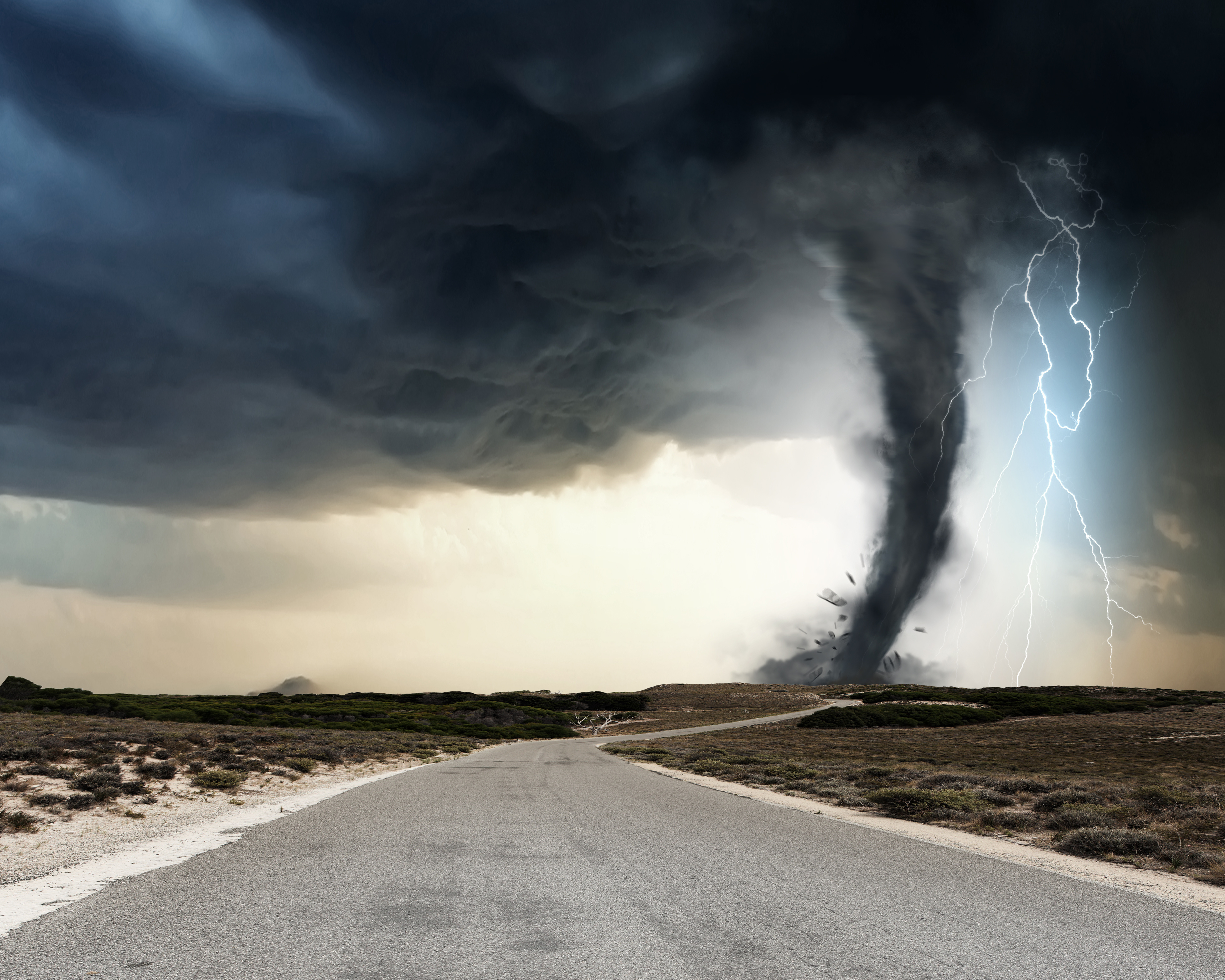 A tornado tearing through the country side with a lighting bolt coming down right next to it