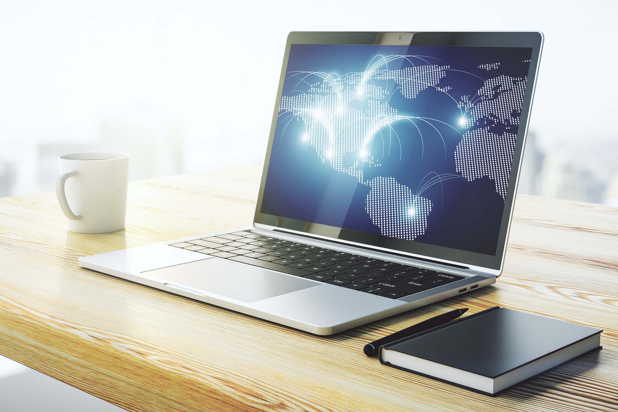 A laptop sitting on a desk next to a cup of coffe with a map made up of LED ligts displayed on the screen