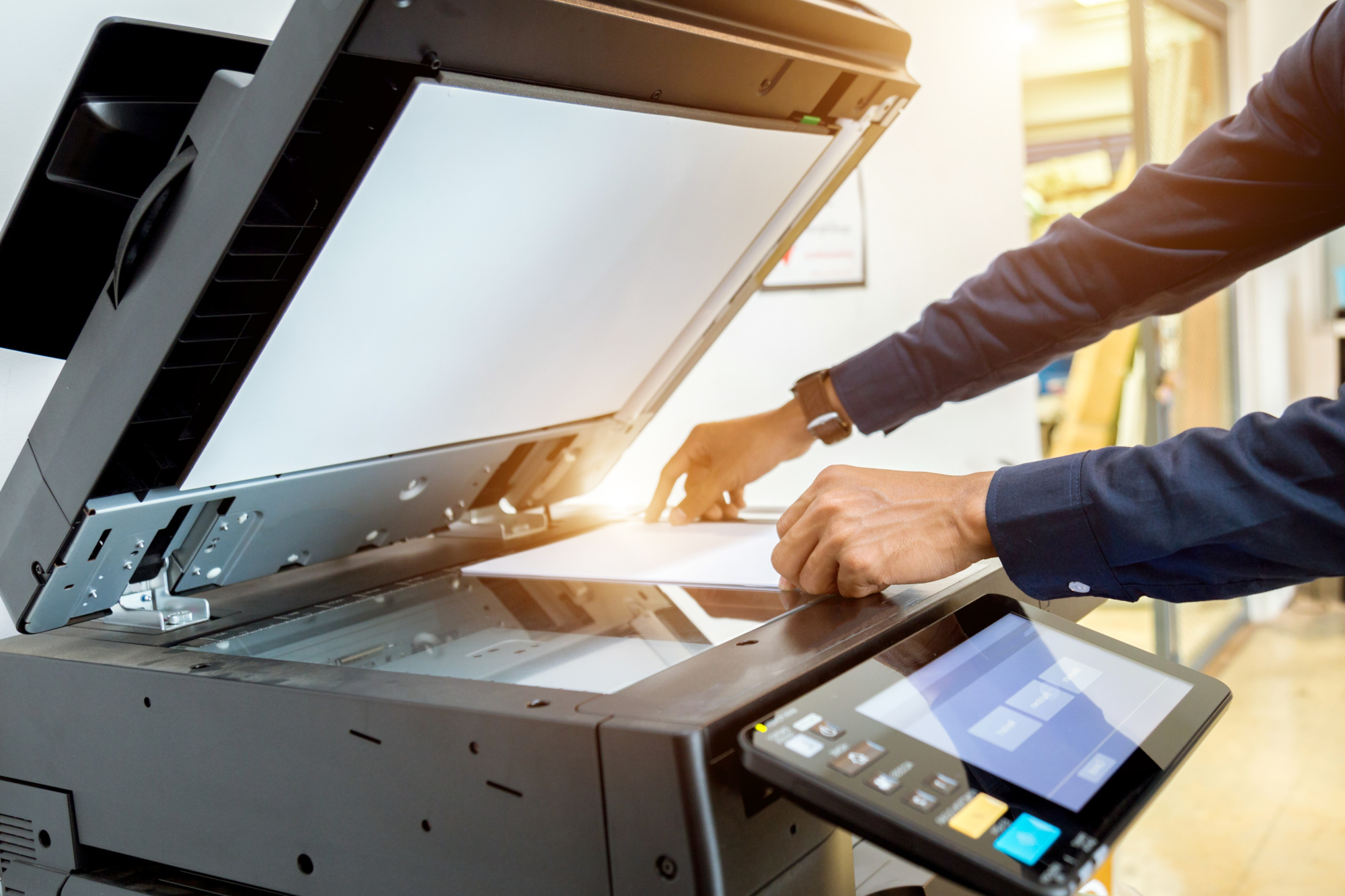 Closeup of and office grade printer/copier being used to scan a document